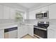 Renovated kitchen features stainless steel appliances, modern cabinets, and a bright, airy design at 212 Gay Rd, Seffner, FL 33584