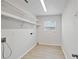 Clean and functional laundry room with ample shelving, natural light, and convenient hookups for modern living at 212 Gay Rd, Seffner, FL 33584
