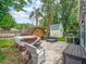 This backyard boasts a patio, a shed, a hot tub, lounge seating, and lush landscaping at 2160 Ne Coachman Rd, Clearwater, FL 33765