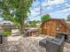 A patio area is furnished with comfortable seating, a jacuzzi, and a small shed at 2160 Ne Coachman Rd, Clearwater, FL 33765