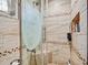 Shower room featuring decorative glass, tiles, a built-in shelf, and a shower head at 2160 Ne Coachman Rd, Clearwater, FL 33765