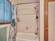This bright bathroom features a shower, and an adjoining door to the hallway at 2160 Ne Coachman Rd, Clearwater, FL 33765