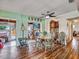 Charming dining room with hardwood floors, vintage decor, and seamless flow into the adjacent living spaces at 2160 Ne Coachman Rd, Clearwater, FL 33765