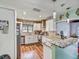 Modern kitchen with white cabinets, granite countertops, stainless steel appliances, and stylish backsplash at 2160 Ne Coachman Rd, Clearwater, FL 33765