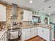 Bright kitchen boasts granite counters, stainless appliances, and unique backsplash at 2160 Ne Coachman Rd, Clearwater, FL 33765