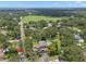 Aerial view featuring a large lot with mature trees, spacious lawn, and a serene neighborhood at 2306 S Valrico Rd, Valrico, FL 33596