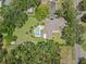 Aerial of home highlights large lot, mature trees, pool, and spacious backyard at 2306 S Valrico Rd, Valrico, FL 33596