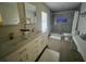 Bright bathroom featuring a double vanity, wood floors and a glass enclosed shower at 2306 S Valrico Rd, Valrico, FL 33596