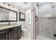 Modern bathroom featuring a granite countertop, a vanity, and a glass shower at 2306 S Valrico Rd, Valrico, FL 33596