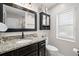 Modern bathroom featuring a granite countertop, and a large mirror at 2306 S Valrico Rd, Valrico, FL 33596