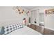 Cozy bedroom featuring a decorative wall, and light-filled space with dark wood floors at 2306 S Valrico Rd, Valrico, FL 33596