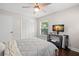 Bedroom with a ceiling fan, dark wood floors and a TV on a small desk at 2306 S Valrico Rd, Valrico, FL 33596