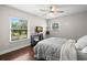 Bedroom with a ceiling fan and two windows with lots of natural light at 2306 S Valrico Rd, Valrico, FL 33596