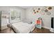 Bedroom with a bed, modern wood-look floors, updated wall decor, and lots of natural light at 2306 S Valrico Rd, Valrico, FL 33596