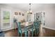 Dining room features wood floors, plantation shutters, rustic chandelier and an 'EAT' decoration at 2306 S Valrico Rd, Valrico, FL 33596