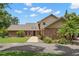 Charming brick home with a well-manicured lawn, complemented by mature trees and landscaping at 2306 S Valrico Rd, Valrico, FL 33596