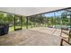 Screened-in patio overlooking the manicured backyard and private pool, perfect for outdoor living and entertaining at 2306 S Valrico Rd, Valrico, FL 33596