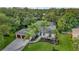 Aerial view of a beautiful home featuring a spacious layout, lush landscaping, and a three-car garage at 2435 Fox Forest Dr, Lutz, FL 33549