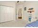 Bright bedroom with neutral-toned walls, a spacious closet, and a glimpse into the rest of the home at 2435 Fox Forest Dr, Lutz, FL 33549