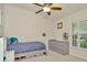 Bedroom featuring neutral tones, natural light from the window, and a ceiling fan to ensure comfort at 2435 Fox Forest Dr, Lutz, FL 33549