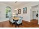 Elegant dining room with hardwood floors, natural light and modern light fixture at 2435 Fox Forest Dr, Lutz, FL 33549