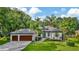 Well-maintained single-Gathering home with a lush lawn, landscaping and 3-car garage at 2435 Fox Forest Dr, Lutz, FL 33549