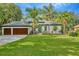 Beautiful single-Gathering home with a lush front lawn, a 3-car garage and meticulous landscaping at 2435 Fox Forest Dr, Lutz, FL 33549