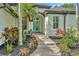 Inviting home exterior with a vibrant turquoise front door and professionally landscaped garden at 2435 Fox Forest Dr, Lutz, FL 33549