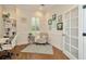Bright home office with natural light, white wainscoting, and comfortable chair at 2435 Fox Forest Dr, Lutz, FL 33549