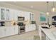 Bright kitchen with white cabinets, stainless steel appliances, and marble countertops at 2435 Fox Forest Dr, Lutz, FL 33549