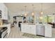 Open kitchen with stainless steel appliances, a large island, and views of the living area at 2435 Fox Forest Dr, Lutz, FL 33549