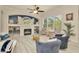 Cozy living room with fireplace, large windows, and comfortable seating at 2435 Fox Forest Dr, Lutz, FL 33549