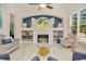 Inviting living room featuring a fireplace, vaulted ceilings, bright windows and stylish decor and furniture at 2435 Fox Forest Dr, Lutz, FL 33549