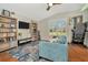 Inviting living room with hardwood floors, built-in shelving, and a comfortable blue sofa at 2435 Fox Forest Dr, Lutz, FL 33549