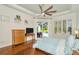 Serene main bedroom featuring hardwood floors, tray ceiling, and a sliding door to the outdoor living area at 2435 Fox Forest Dr, Lutz, FL 33549