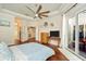 Spacious main bedroom with hardwood floors, ceiling fan, and access to ensuite bathroom at 2435 Fox Forest Dr, Lutz, FL 33549