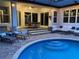 Outdoor patio featuring lounge furniture, a dining area, and a pool for relaxation and entertaining at 2435 Fox Forest Dr, Lutz, FL 33549