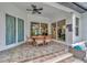 Outdoor patio with tile flooring, ceiling fan, and comfortable seating area for relaxation at 2435 Fox Forest Dr, Lutz, FL 33549
