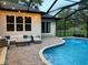 Inviting pool area with outdoor seating, perfect for relaxing and enjoying the outdoors at 2435 Fox Forest Dr, Lutz, FL 33549