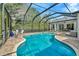 Beautiful screened-in pool with brick patio and outdoor seating area at 2435 Fox Forest Dr, Lutz, FL 33549
