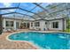 Enjoy this screened-in pool with an attached spa, outdoor lounge and dining area perfect for relaxing and entertaining at 2435 Fox Forest Dr, Lutz, FL 33549
