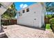 Private backyard featuring brick pavers, a lush garden, and a bright white house at 258 14Th Ne Ave, St Petersburg, FL 33701