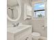 Bright bathroom with updated vanity, oval mirror, and walk-in shower at 258 14Th Ne Ave, St Petersburg, FL 33701