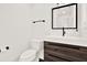 Modern powder room features a floating wood vanity, black hardware, and contrasting white walls at 258 14Th Ne Ave, St Petersburg, FL 33701