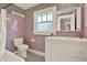 Vintage pink bathroom features a bathtub, toilet, tiled walls, and a double sink vanity at 258 14Th Ne Ave, St Petersburg, FL 33701