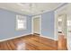 Cozy bedroom with wood floors, pastel walls, a ceiling fan, and an adjacent doorway at 258 14Th Ne Ave, St Petersburg, FL 33701