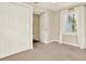 Bright bedroom featuring a large closet, a window with white curtains, and neutral carpet at 258 14Th Ne Ave, St Petersburg, FL 33701