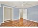 Bedroom with hardwood floors, light blue walls, and a ceiling fan at 258 14Th Ne Ave, St Petersburg, FL 33701