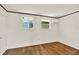 Bright bedroom with hardwood floors, mini-split air conditioner, and two windows at 258 14Th Ne Ave, St Petersburg, FL 33701