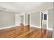 Spacious bedroom with hardwood floors, neutral paint, crown molding, and multiple entryways at 258 14Th Ne Ave, St Petersburg, FL 33701